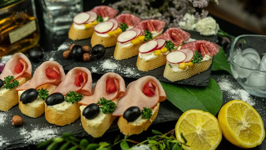 A variety of gourmet sandwiches with fresh ingredients like ham, salami, and black olives, perfect for a delicious meal.